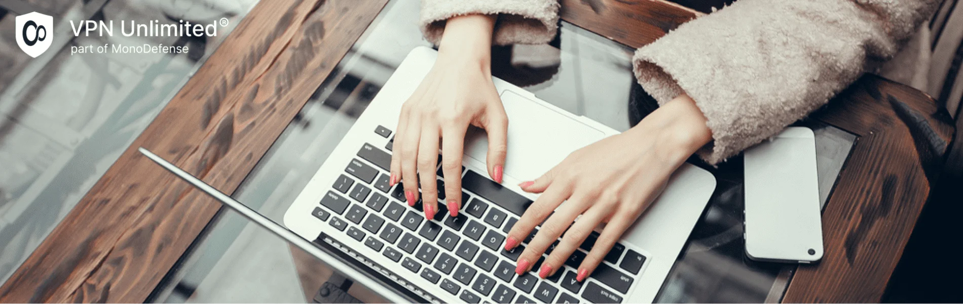 Young woman using laptop in cafe, using tips and tricks of using VPN Unlimited on Mac