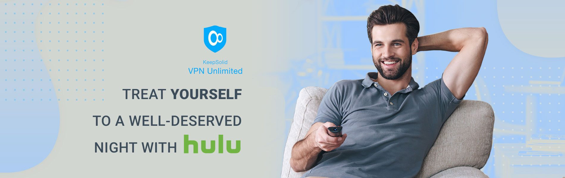 Handsome cheerful young man holding remote control and watching Hulu TV outside the US while sitting on the couch